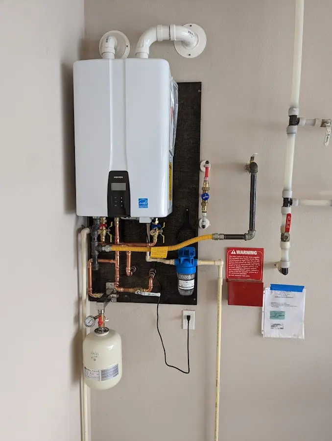 Professional plumber installing copper piping in a Vernon home